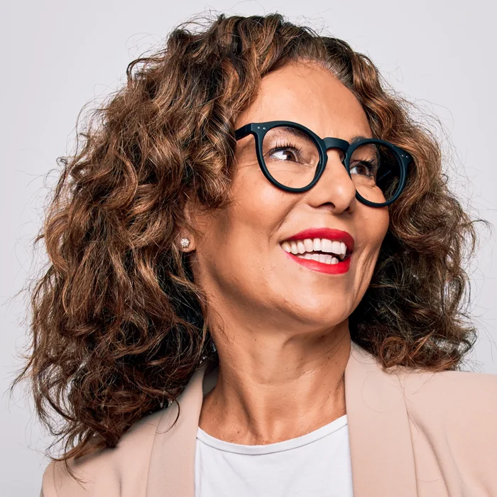 Middle age beautiful businesswoman wearing glasses standing over isolated white background looking to side, relax profile pose with natural face and confident smile.