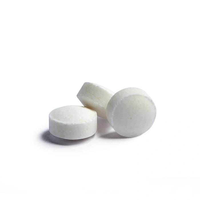 White round pills isolated on a white background. A heap of small round meds. Health care and medicine concept