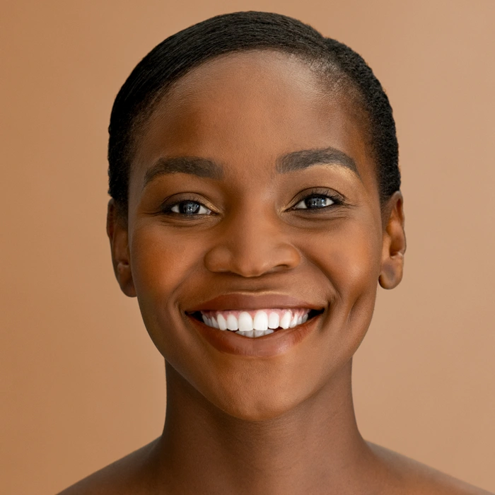 Portrait of middle aged beautiful african woman with bare shoulder against panoramic background.