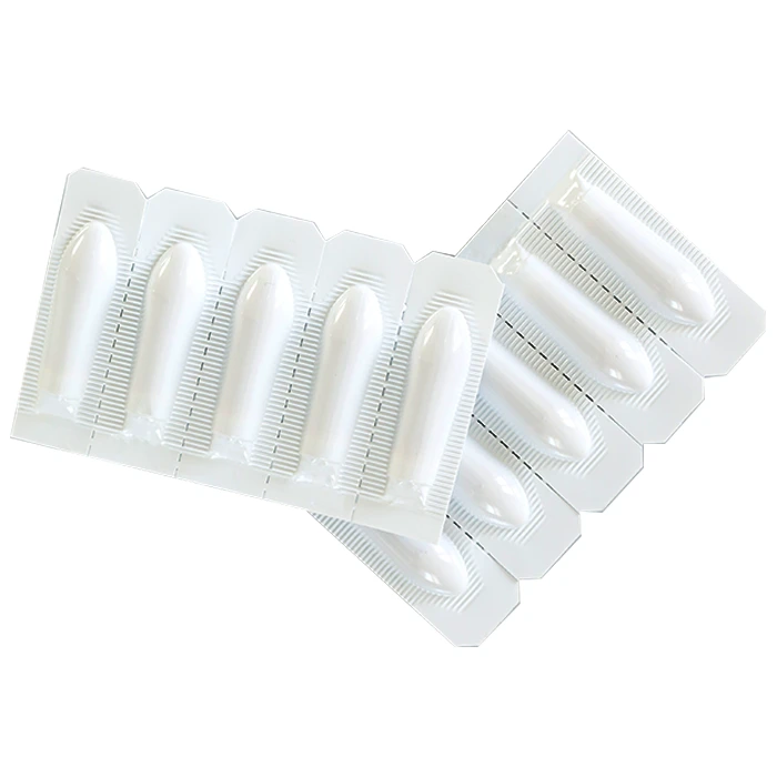 Suppository for vaginal or anal use on gray background top view.