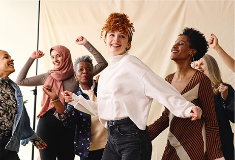 candid portrait of multi ethnic mixed age range women dancing