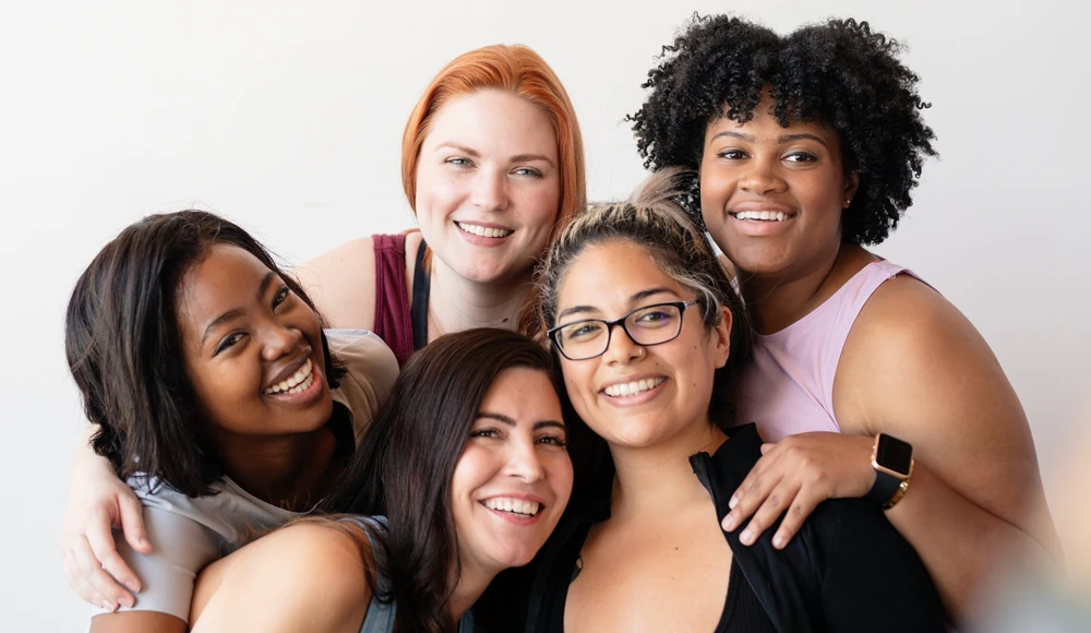 Happy diverse group of sportswomen in activewear