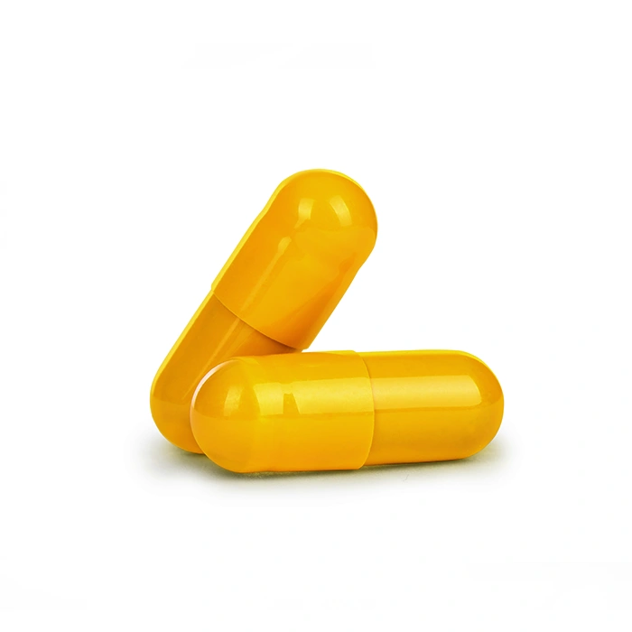 Close-up two yellow medical capsules isolated on white background