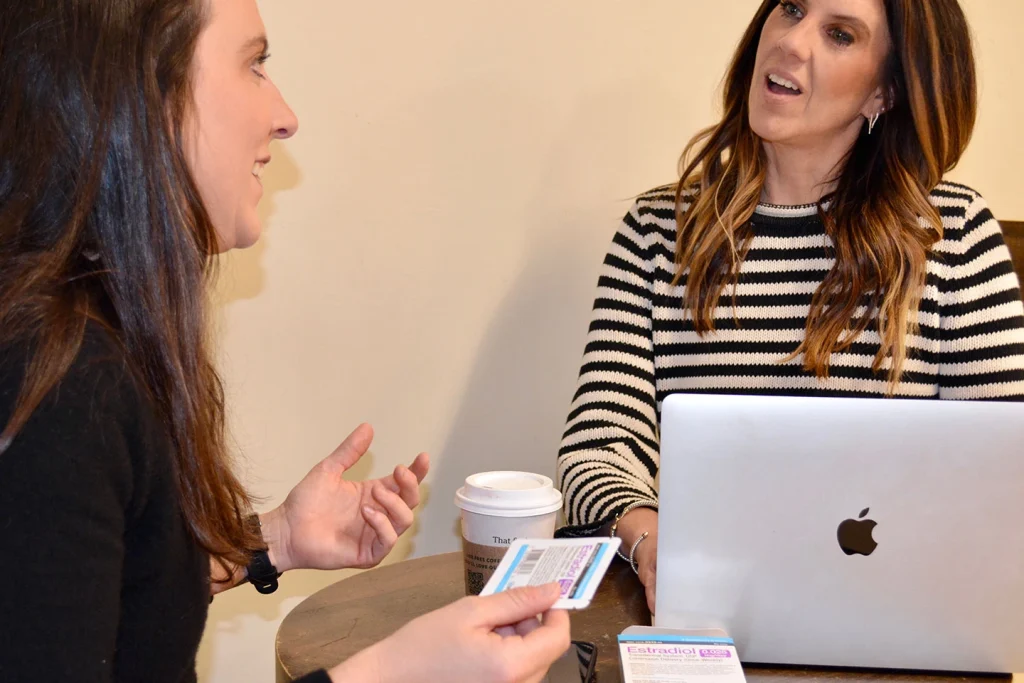 Woman in her 40s discussing hormone therapy options for perimenopause symptoms with a healthcare provider